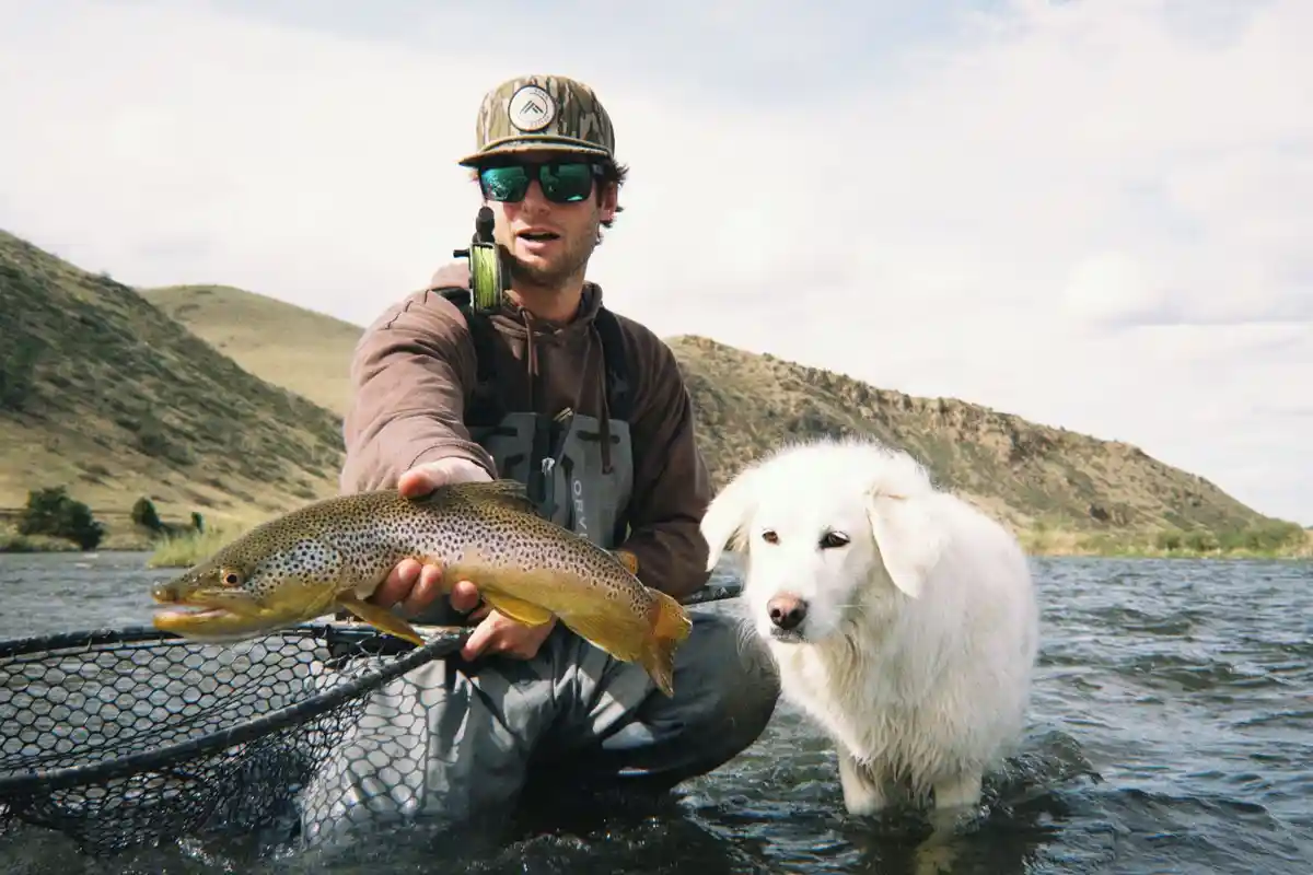 Montana fly fishing — guide with a brown trout